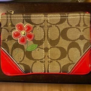 Authentic Coach wristlet with flower detail- like new!